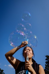Wake Forest students, faculty, and staff attend the Arrive to Thrive event on Manchester Plaza on Tuesday, August 25, 2015. The event highlights different ways of maintaining an healthy lifestyle on campus. Rae-Ling Lee ('17) blows giant bubbles.