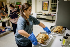 Wake Forest students cook and deliver Thanksgiving meals during the annual Turkeypalooza event held by the volunteer organization Campus Kitchen on Thursday, November 19, 2015. Hailey Estes ('16) takes the finished turkey breasts out of the roasting pans.