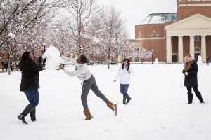 Wake Forest students take advantage of a rare snow day to build snowmen and have snowball fights on Hearn Plaza on Thursday, February 26, 2015. Emma Kook ('18), in ear muffs, Cardinal Do ('17), in white jacket, Edima Udom ('18), in gray, and Phylicia Montaque ('18), in black coat, have a little snowball fight among friends.