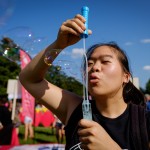 Wake Forest students, faculty, and staff attend the Arrive to Thrive event on Manchester Plaza on Tuesday, August 25, 2015. The event highlights different ways of maintaining an healthy lifestyle on campus. Rae-Ling Lee ('17) blows giant bubbles.