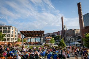 The Blue Ridge Music Center hosts a free bluegrass concert at Bailey Park in downtown Winston-Salem on Friday, June 3, 2016. Wake Forest Innovation Quarter is in the background.